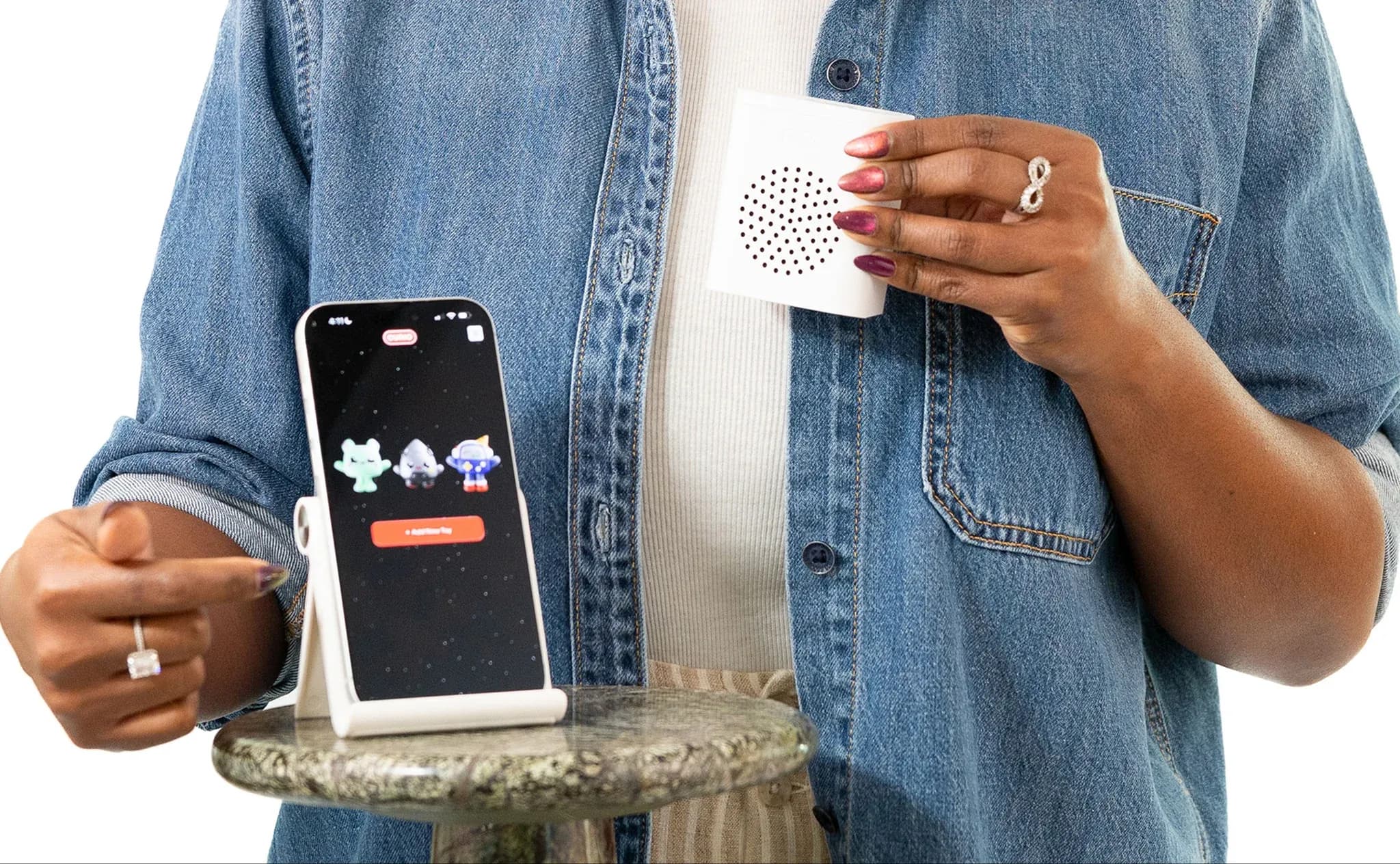 Woman holding curio voicebox 2 and app