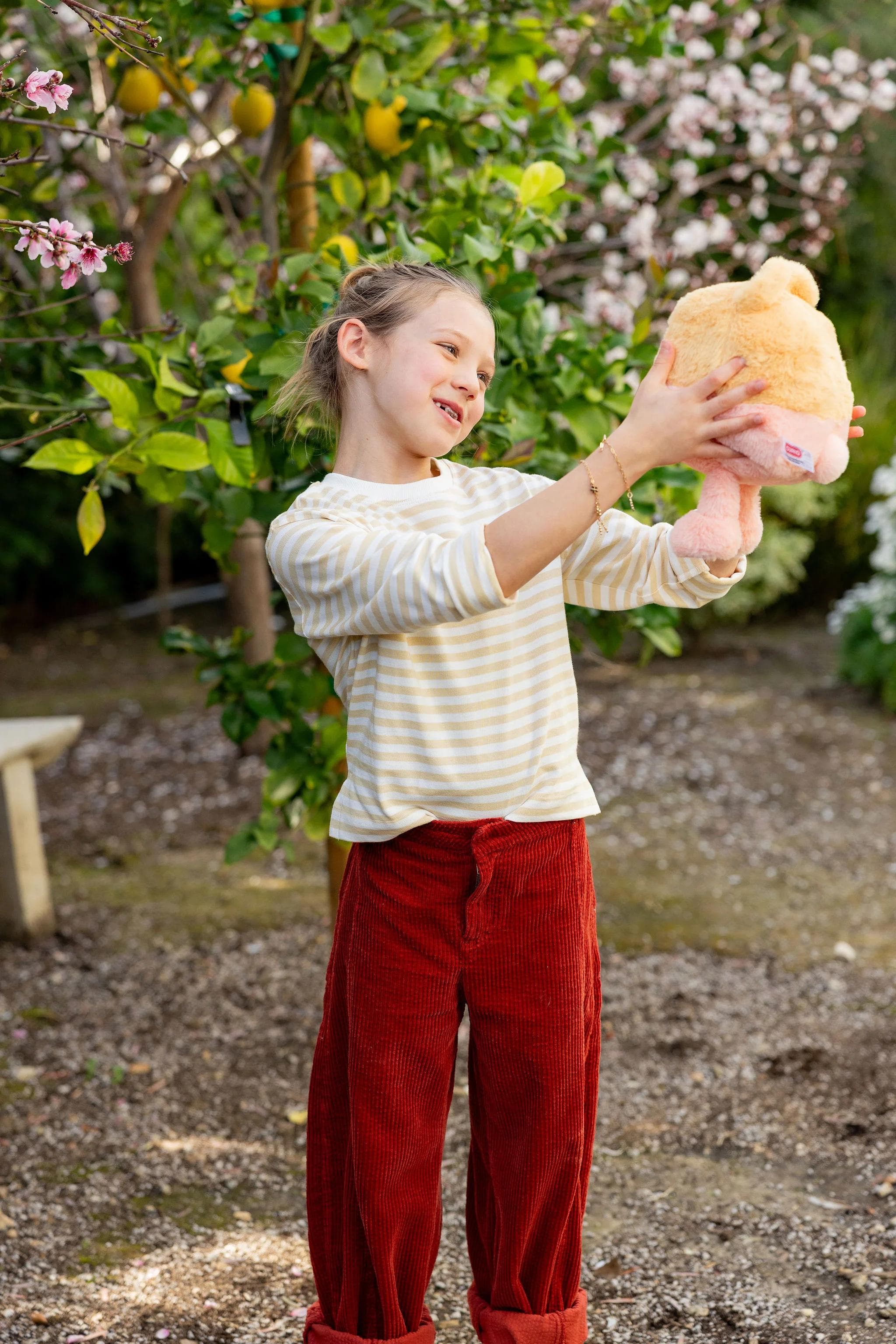 Girl holding poppy AI Bear in the air