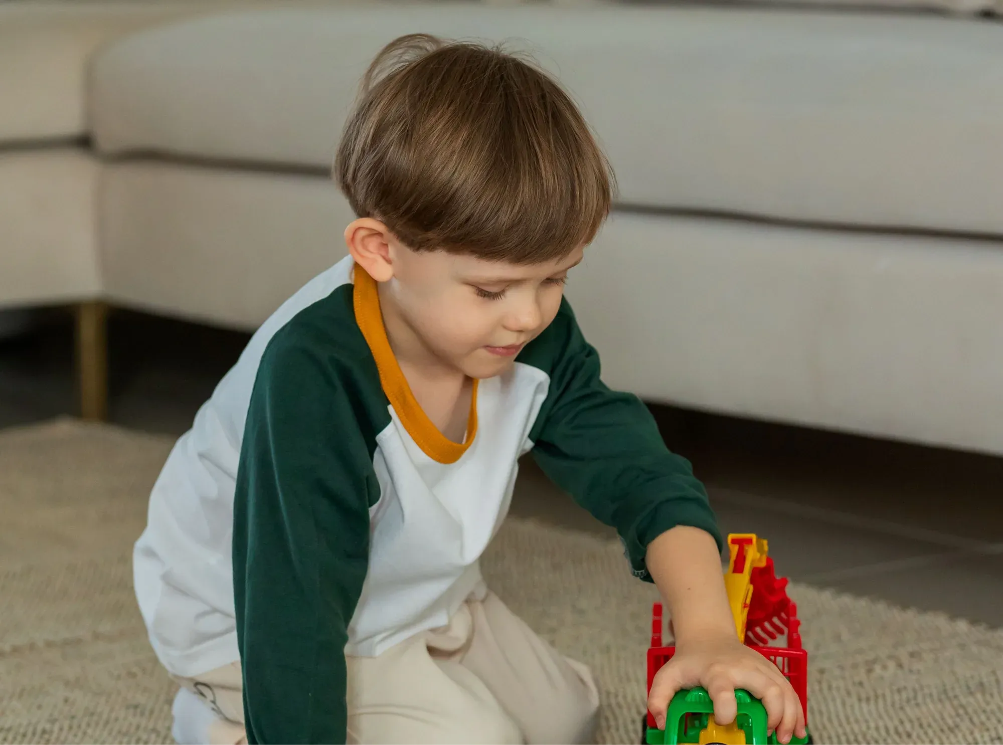 Child playing with toy train