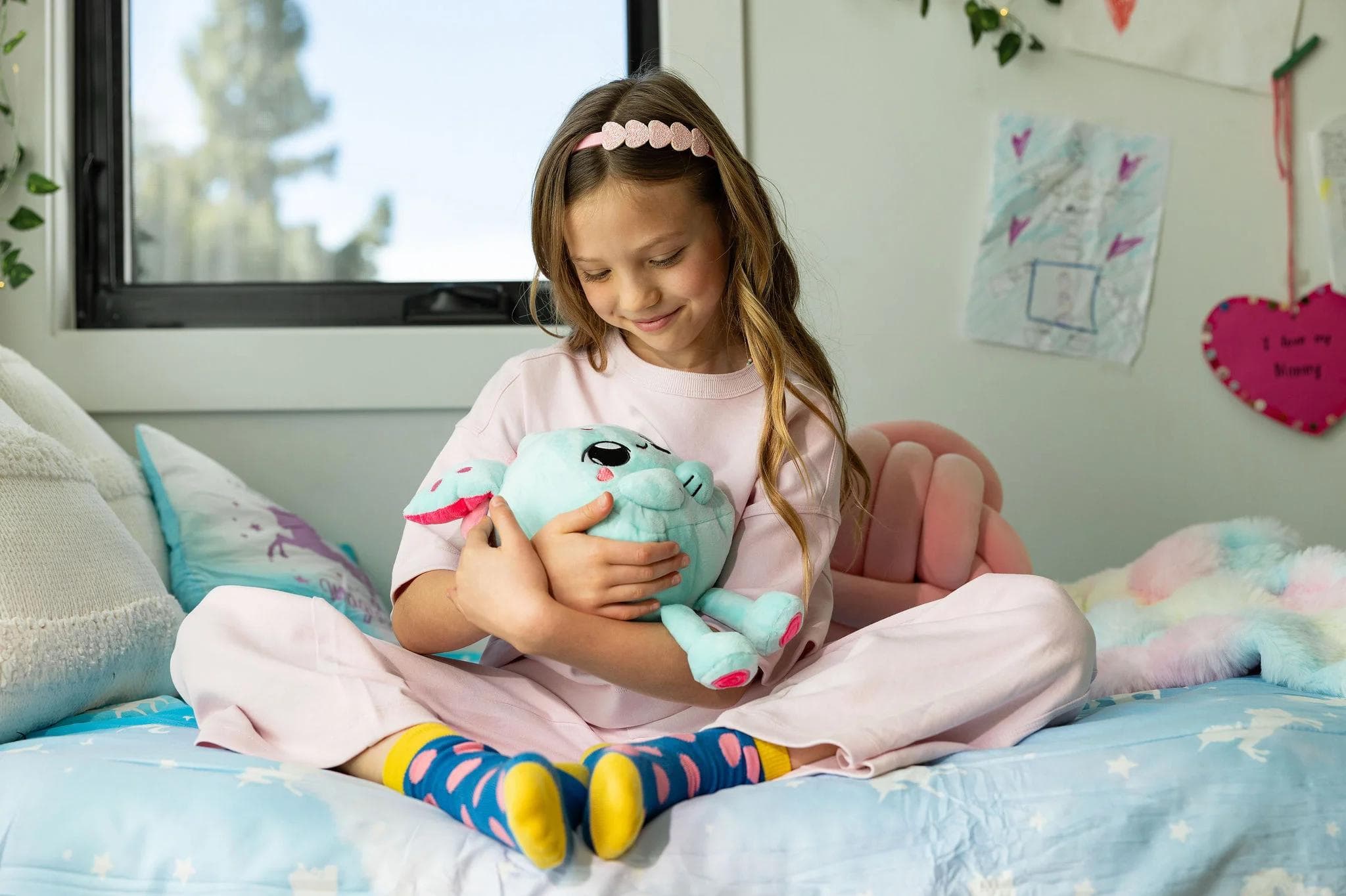 Girl playing with Curio toy on her bed