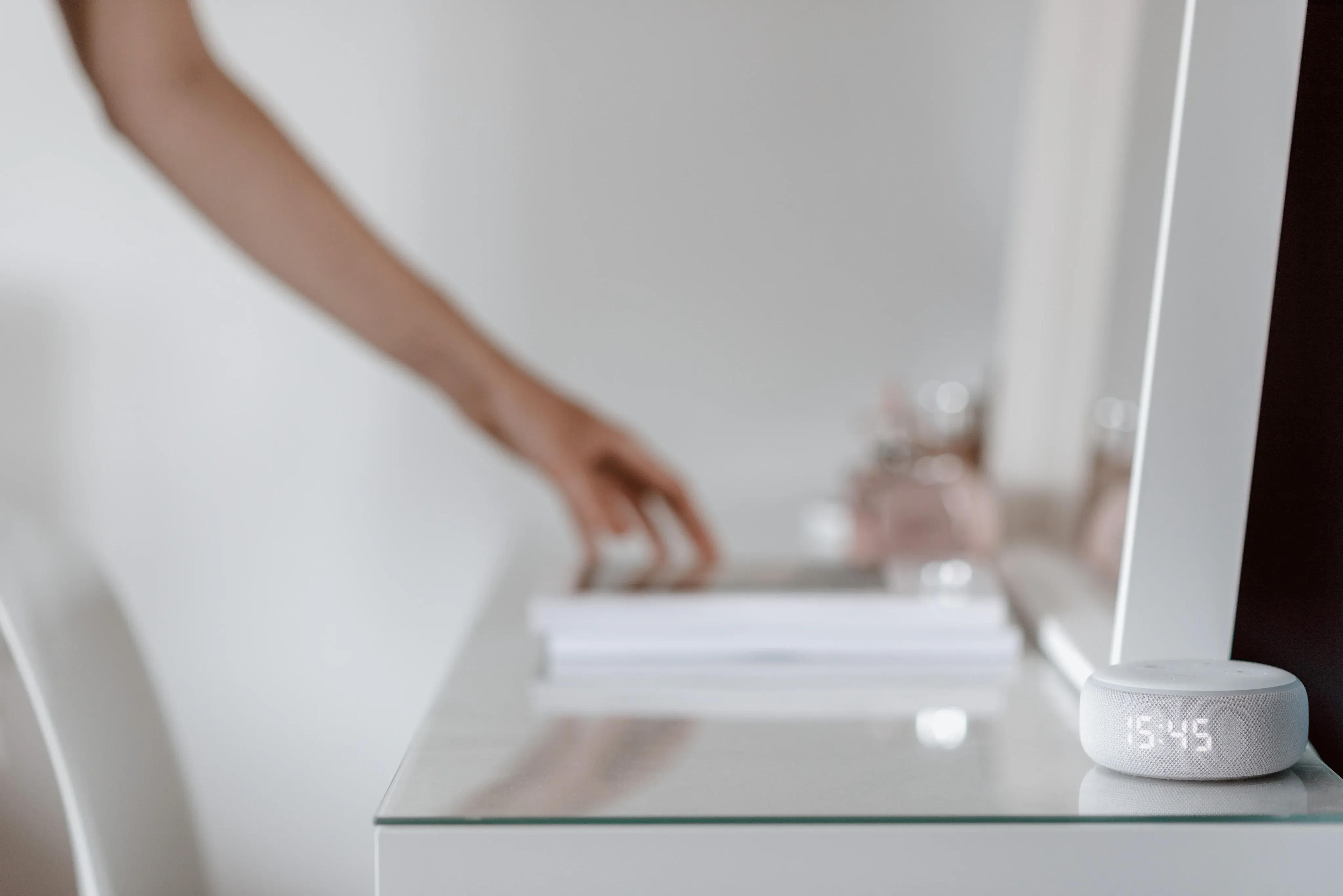Woman touching counter top with amazon alexa on it
